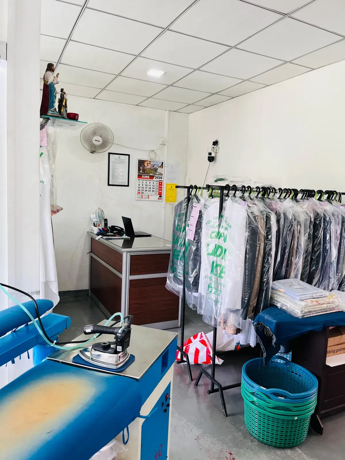 Front counter and a rail of finished garments in Champion branded covers at our Gampaha shop