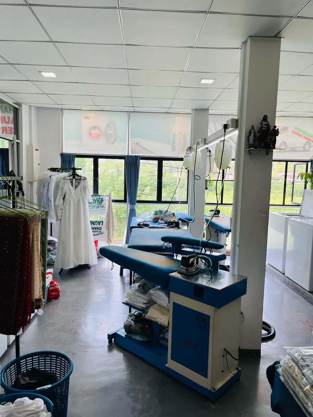 The bright, spacious shop floor with pressing tables at Champion Laundry, Gampaha