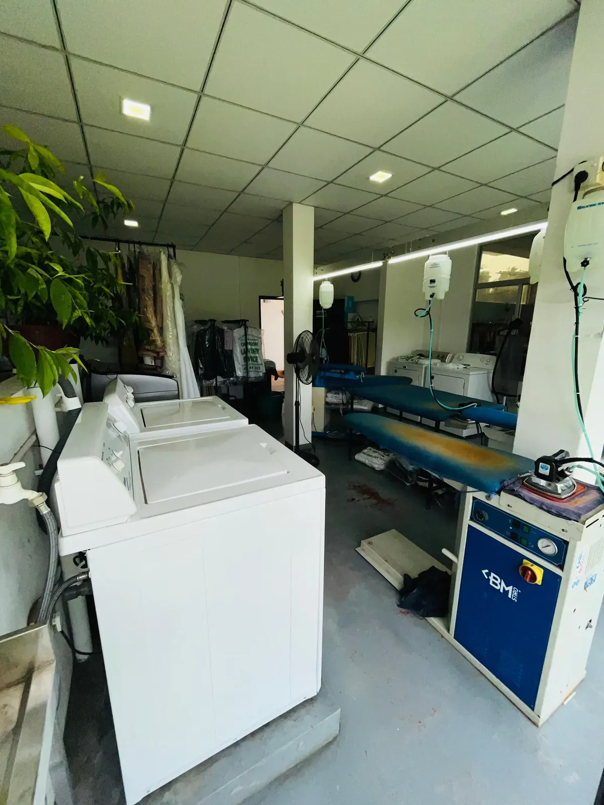 Washing machines and the pressing area inside Champion Laundry, Gampaha